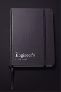 The Engineer's Field Book closed, matte black dot-textured hardcover with elastic closure and ribbon marker