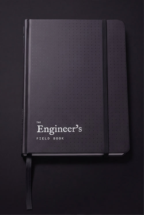 The Engineer's Field Book closed, matte black dot-textured hardcover with elastic closure and ribbon marker